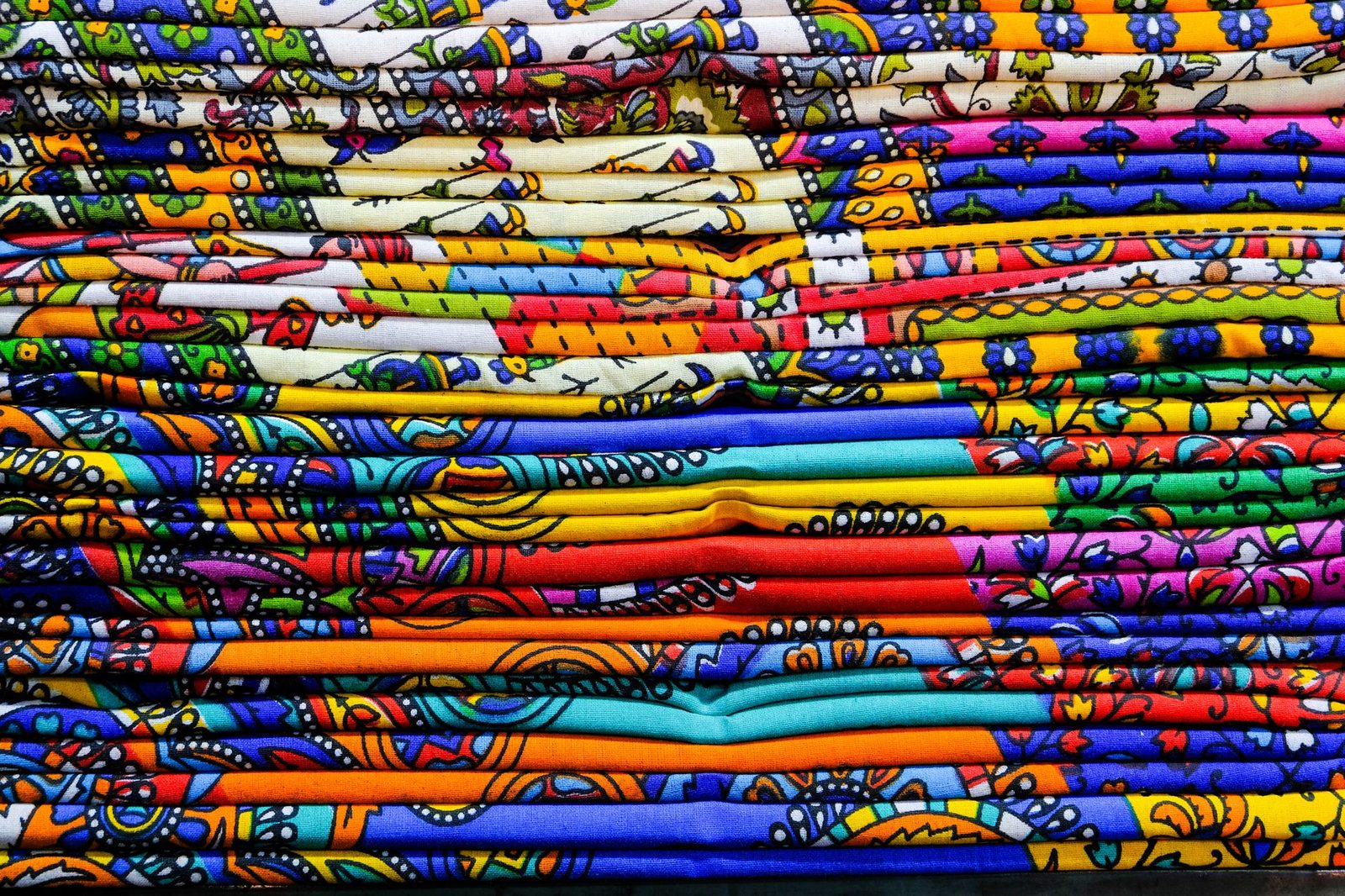 Close-up of colorful Indian textiles showcasing traditional patterns in Jaipur, India.