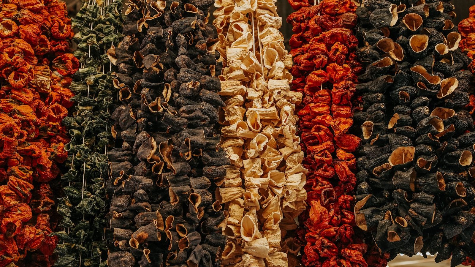 Colorful rows of dried vegetables creating a textured pattern, perfect for culinary backgrounds.