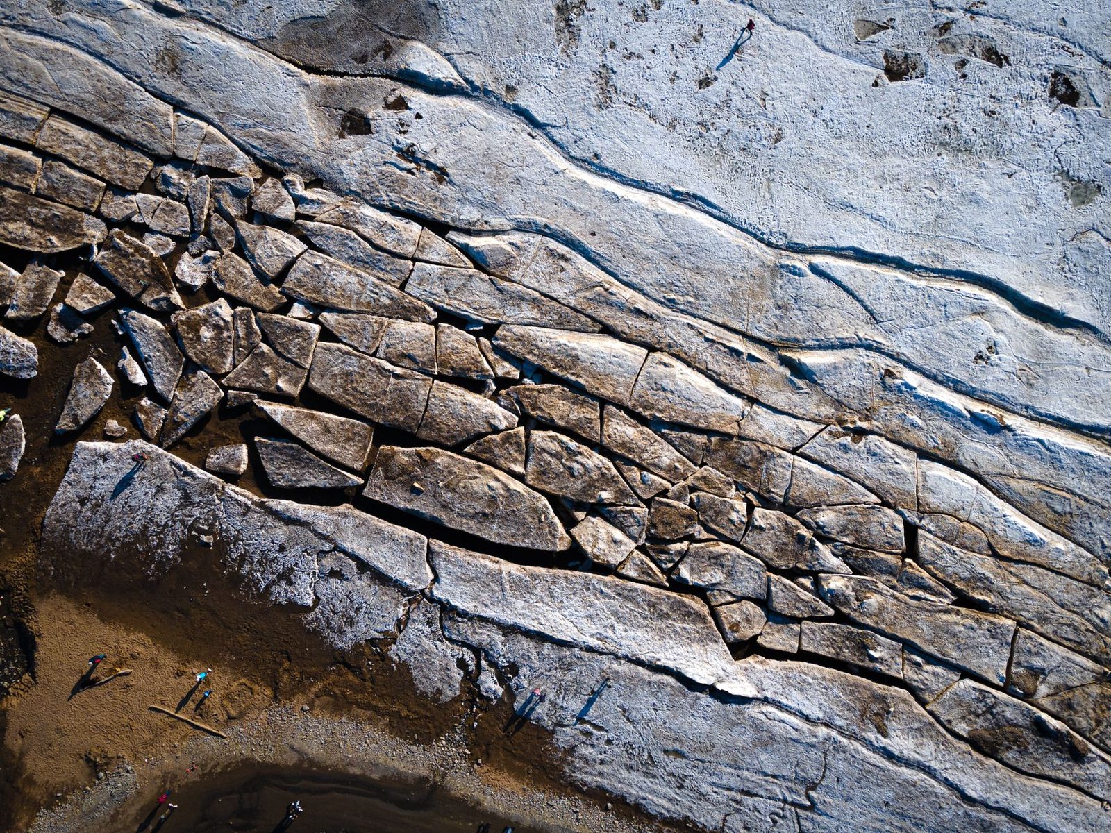 Stunning aerial image of a cracked earth surface with large rock formations.