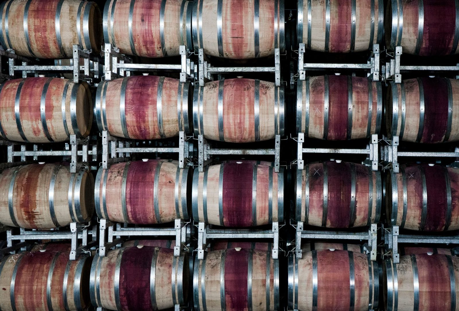 Stacked wooden barrels in a winery store wine, highlighting the art of winemaking.