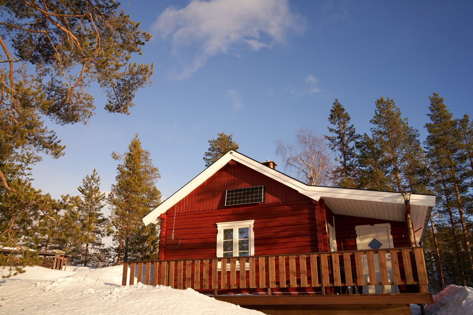 Idyllic red cabin in a serene snowy forest in Krøderen, Norway, showcasing Scandinavian simplicity.