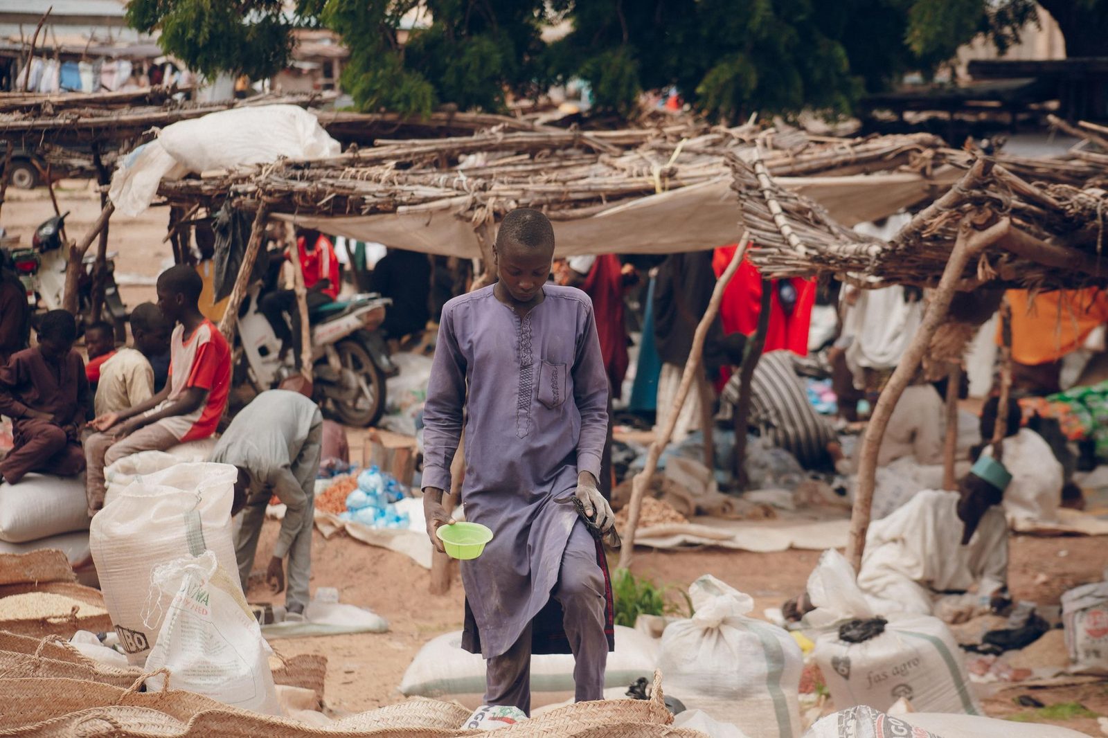 An African market scene with vendors and goods, capturing daily life and community.