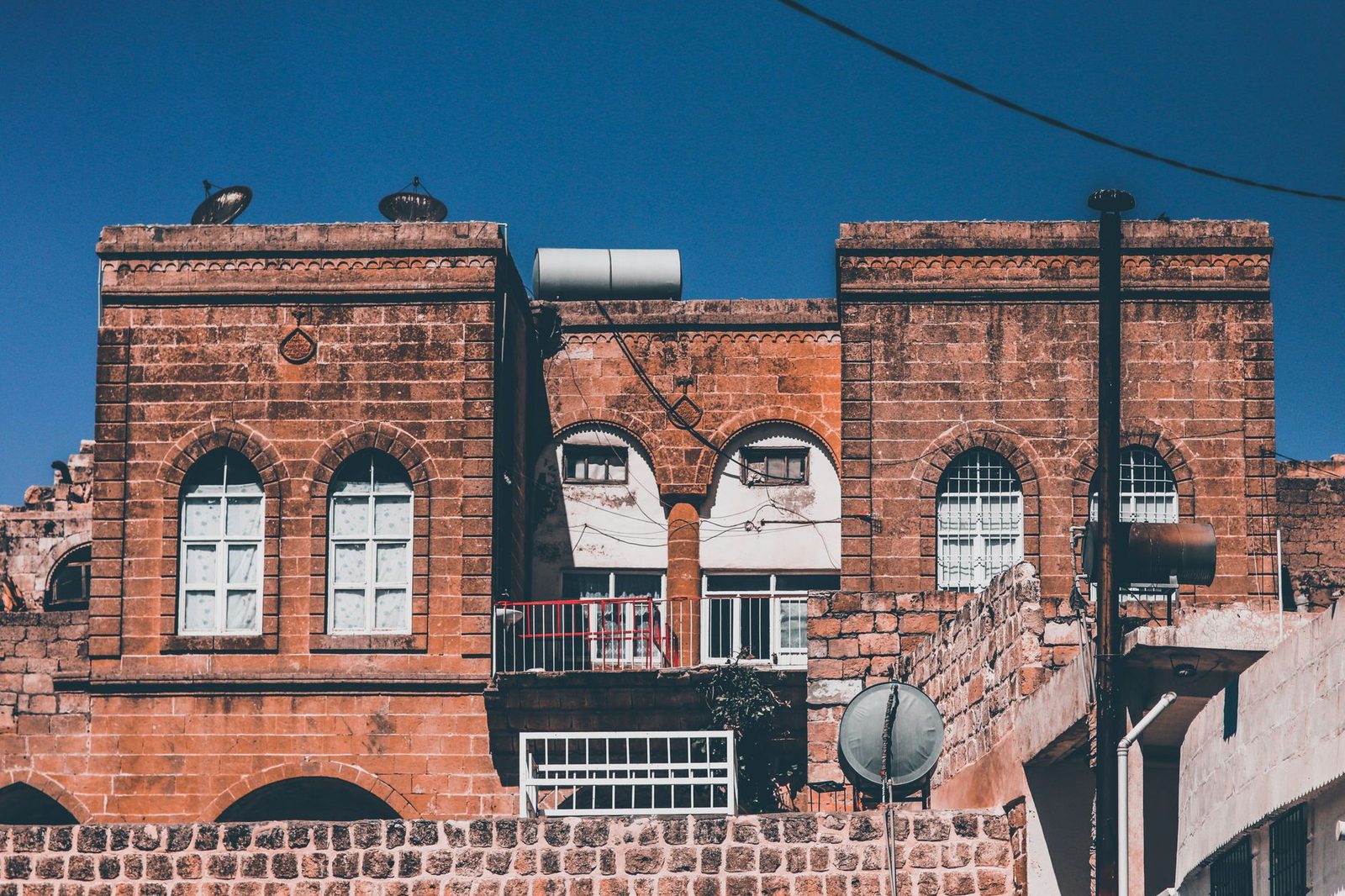 Stunning view of a traditional red brick building facade against a clear blue sky.