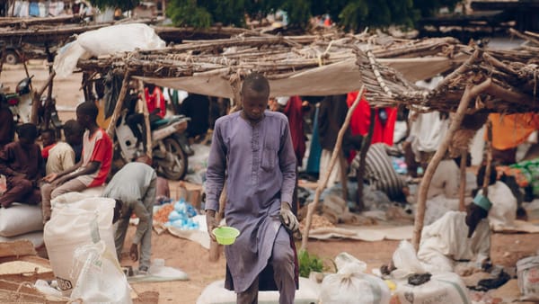An African market scene with vendors and goods, capturing daily life and community.