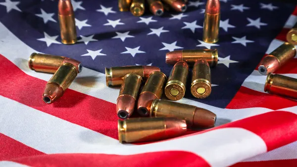 Close-up of ammunition on the American flag, signifying defense and patriotism.