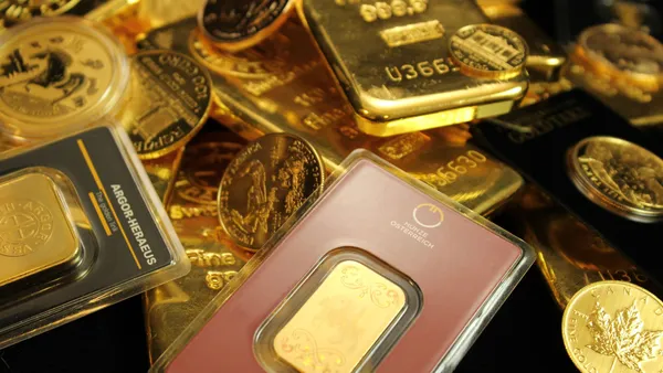 Detailed close-up of gold bars and coins symbolizing wealth and investment opportunities.