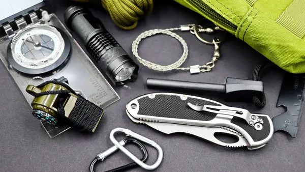 A comprehensive layout of essential survival tools including compass, flashlight, and knife, perfect for outdoor adventures.