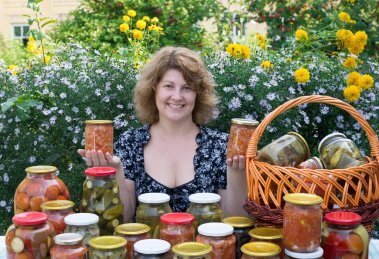Woman showing off her canning work