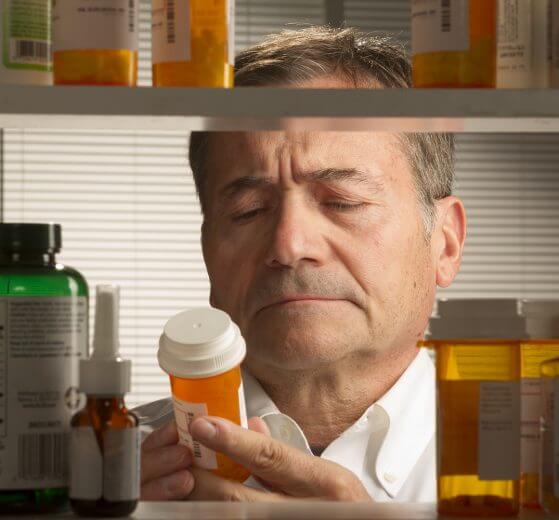 Prepper looking at drug expiration dates for medicine